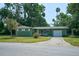 Charming single-story home with green exterior, attached garage, and well-maintained lawn at 1301 Oakwood Ave, Daytona Beach, FL 32114