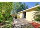 Backyard with outdoor patio seating and sliding door with landscaped space at 1465 Admrial Nimitz Ave, Daytona Beach, FL 32124