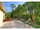 Cozy backyard patio with seating area surrounded by lush greenery and landscaping at 1465 Admrial Nimitz Ave, Daytona Beach, FL 32124