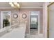 Elegant bathroom featuring a spacious vanity, a large mirror, and access to the bedroom and shower at 1465 Admrial Nimitz Ave, Daytona Beach, FL 32124