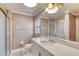 Bright bathroom with a large mirror, white vanity, a shower with glass door, and neutral wall color at 1465 Admrial Nimitz Ave, Daytona Beach, FL 32124