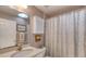Bathroom with white vanity, neutral wall color, shower with curtain and a sklight at 1465 Admrial Nimitz Ave, Daytona Beach, FL 32124