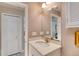 Bathroom featuring a white vanity, large mirror, and a view to the bedroom and closet at 1465 Admrial Nimitz Ave, Daytona Beach, FL 32124