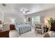 Cozy bedroom features a ceiling fan, a window with blinds, and light-colored walls at 1465 Admrial Nimitz Ave, Daytona Beach, FL 32124