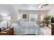 Cozy bedroom features a ceiling fan, a window with blinds, and light-colored walls at 1465 Admrial Nimitz Ave, Daytona Beach, FL 32124