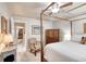 Bedroom with a four poster bed, ceiling fan, carpeted floor and view to another room at 1465 Admrial Nimitz Ave, Daytona Beach, FL 32124