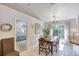 Open dining room with chandelier and sliding doors to the backyard at 1465 Admrial Nimitz Ave, Daytona Beach, FL 32124