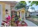 Inviting yellow home exterior with well-maintained landscaping, bench, and decorative house number at 1465 Admrial Nimitz Ave, Daytona Beach, FL 32124