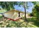 Rear exterior view of home with a patio and tree shading backyard at 1465 Admrial Nimitz Ave, Daytona Beach, FL 32124