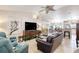 Bright living room with tile floors, ceiling fan, and open concept design into kitchen at 1465 Admrial Nimitz Ave, Daytona Beach, FL 32124