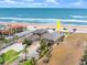 Aerial view of beachfront home with a view of the ocean and direct beach access at 1504 N Atlantic Ave, Daytona Beach, FL 32118