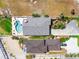 Aerial view shows a pool next to a beach home with lush tropical landscaping at 1504 N Atlantic Ave, Daytona Beach, FL 32118