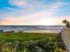 Serene beachfront view showcasing ocean waves, blue sky, and lush vegetation at this gorgeous property at 1504 N Atlantic Ave, Daytona Beach, FL 32118