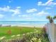 Scenic beach view with stepping stones leading to the sandy shores and tranquil ocean waves at 1504 N Atlantic Ave, Daytona Beach, FL 32118