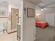 Hallway featuring a full bedroom with a double closet, accompanied by an adjacent full bathroom at 1504 N Atlantic Ave, Daytona Beach, FL 32118