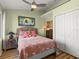 Charming bedroom featuring a cozy bed, unique decor, ceiling fan, and ample natural light at 1504 N Atlantic Ave, Daytona Beach, FL 32118