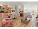 Dining area showcasing a glass table, decorative chairs, wood floors, and easy access to ocean views through large windows at 1504 N Atlantic Ave, Daytona Beach, FL 32118