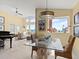 Dining area with seating for six featuring a glass table and wicker chairs with views of the ocean and adjacent living spaces at 1504 N Atlantic Ave, Daytona Beach, FL 32118