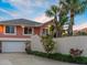 Charming home with a two-car garage and lush, tropical landscaping for added privacy at 1504 N Atlantic Ave, Daytona Beach, FL 32118