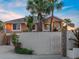 Charming pink two-story home with landscaped yard and palm trees creating a tropical oasis at 1504 N Atlantic Ave, Daytona Beach, FL 32118