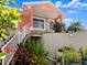 Home exterior showcases lush greenery, white stairs, stone accents, and a well-maintained lawn at 1504 N Atlantic Ave, Daytona Beach, FL 32118