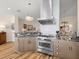 Well-equipped kitchen with stainless steel stove, custom cabinetry, and tiled backsplash at 1504 N Atlantic Ave, Daytona Beach, FL 32118