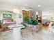 Bright living room featuring stone accent wall, travertine floors, and views into an adjacent bedroom and the ocean at 1504 N Atlantic Ave, Daytona Beach, FL 32118