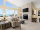 Bright living room features ocean views from large windows, with a sleek fireplace and modern decor at 1504 N Atlantic Ave, Daytona Beach, FL 32118