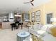 Living room featuring tile floors and an adjacent kitchen area with stainless appliances and ocean views through the windows at 1504 N Atlantic Ave, Daytona Beach, FL 32118