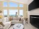 Coastal living room with fireplace and ocean views from the large windows at 1504 N Atlantic Ave, Daytona Beach, FL 32118