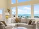 Bright living room featuring a comfortable sectional sofa and stunning ocean views through large windows at 1504 N Atlantic Ave, Daytona Beach, FL 32118