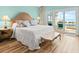 Comfortable main bedroom featuring a king bed and sliding glass doors to deck with ocean view at 1504 N Atlantic Ave, Daytona Beach, FL 32118