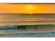 Striking ocean view featuring birds in flight and a vibrant sunrise over the Atlantic at 1504 N Atlantic Ave, Daytona Beach, FL 32118