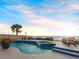 Backyard pool with a beach view and a beautifully landscaped deck with chairs and spa at 1504 N Atlantic Ave, Daytona Beach, FL 32118