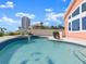 Backyard pool area featuring a spa and a beautifully landscaped deck at 1504 N Atlantic Ave, Daytona Beach, FL 32118