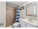 A tiled bathroom with a shower and vanity offers a clean and functional space at 1640 Juno Trl # 105D, Astor, FL 32102