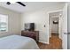 Bright bedroom with wood floors, a dresser, and an attached doorway to another room at 1640 Juno Trl # 105D, Astor, FL 32102