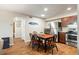Inviting dining area with seating for four, stainless steel appliances, and wood tile floors create a cohesive design at 1640 Juno Trl # 105D, Astor, FL 32102