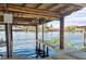 Covered boat dock and lift on the water offering access to the beautiful river, convenient for boating and water activities at 1640 Juno Trl # 105D, Astor, FL 32102