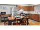 A traditionally styled eat-in kitchen with wood cabinets, stainless steel appliances, and a dining table at 1640 Juno Trl # 105D, Astor, FL 32102