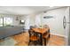 Open concept living space with dining table, comfortable couch and access to screened porch at 1640 Juno Trl # 105D, Astor, FL 32102
