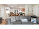 Comfortable living room with a gray sofa and nautical decorations blending into the kitchen and dining area at 1640 Juno Trl # 105D, Astor, FL 32102