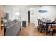 Open-concept living space with wood-look tile floors, neutral paint, and stylish coastal decor creates a welcoming atmosphere at 1640 Juno Trl # 105D, Astor, FL 32102