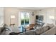Bright living room with a sliding glass door offering natural light and access to the outdoors at 1640 Juno Trl # 105D, Astor, FL 32102