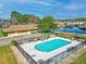 Community pool with lounge chairs surrounded by mature trees and landscaping, near the river and community buildings at 1640 Juno Trl # 105D, Astor, FL 32102