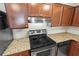 Modern stainless steel stove and dishwasher, complemented by granite countertops in this updated kitchen at 1640 Juno Trl # 105D, Astor, FL 32102