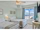Light-filled bedroom boasts ocean views, two twin beds, and beach-themed decor at 2071 S Atlantic Ave # 1005, Daytona Beach Shores, FL 32118