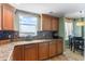 Well appointed kitchen with wood cabinetry, granite countertops and backsplash with a lovely window view at 2071 S Atlantic Ave # 1005, Daytona Beach Shores, FL 32118