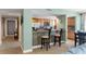 Open kitchen with counter seating, stainless steel appliances, tile backsplash, and easy access to living area at 2071 S Atlantic Ave # 1005, Daytona Beach Shores, FL 32118
