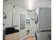 A functional laundry room features a stacked washer and dryer for optimal space use at 2071 S Atlantic Ave # 1005, Daytona Beach Shores, FL 32118